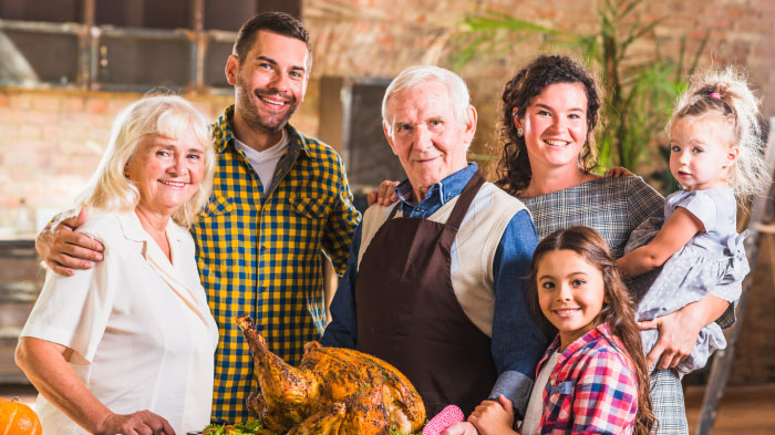 A Thanksgiving photo of a family showing different generations, from the oldest to the youngest. 