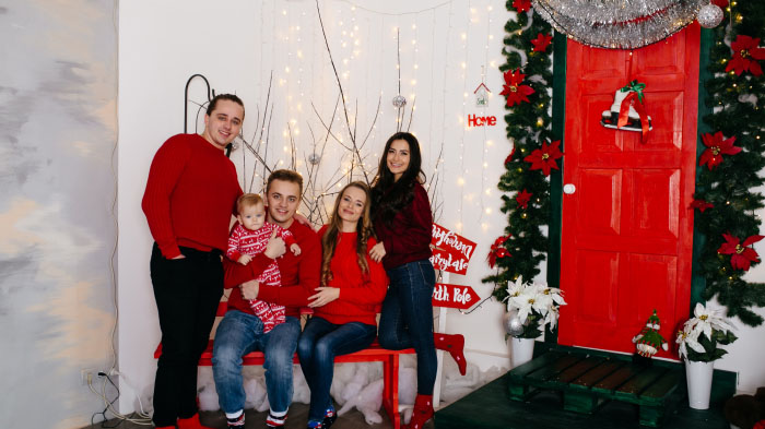  A photo of a family captured in a Christmas-themed setting.