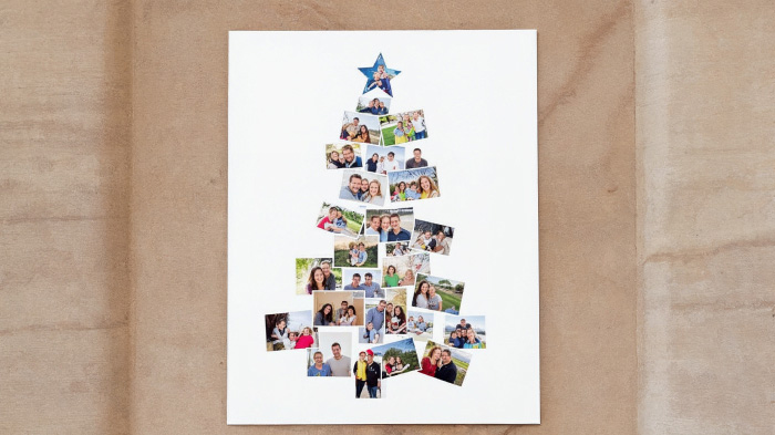 A family gathered around a table creating Christmas cards